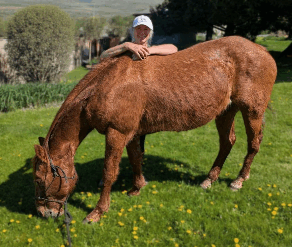 image of Debbie Schulte with her gelding, Duke, one month after rescuing him.
